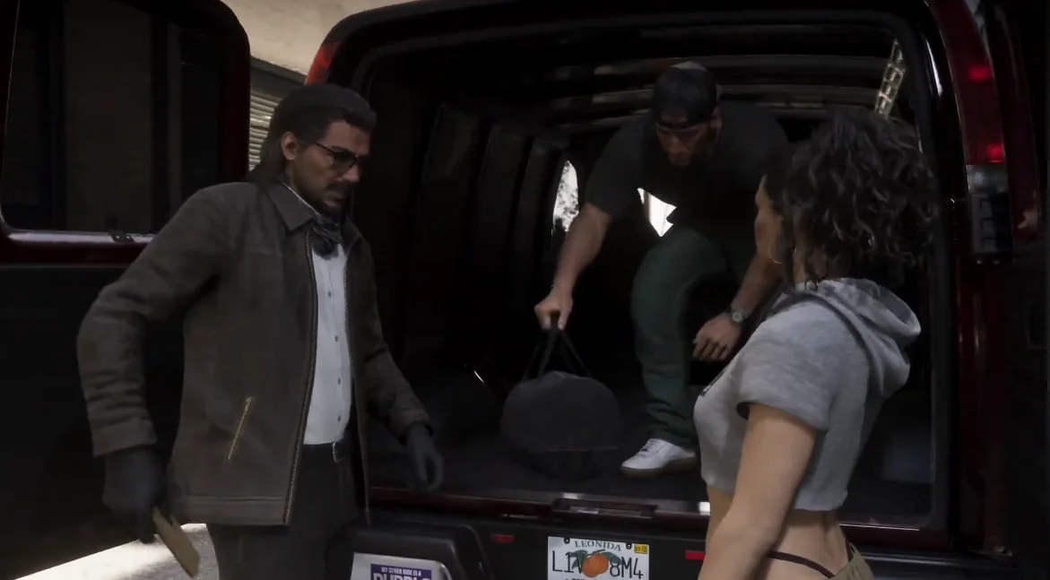 GTA 6 van scene showing layered workwear, dark casual basics, and a cropped gray hoodie